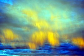 Illuminated clouds mimic Aurora Borealis in eastern sky near Dusk