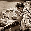 Woman praying, after placing offerings (Behavior: religion)