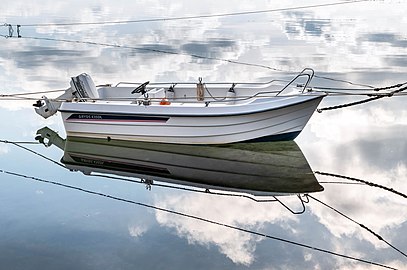 Motorboat Ryds 435DL and cloud reflections in Sämstad harbor