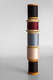 Wooden spools of sewing thread in different colors
