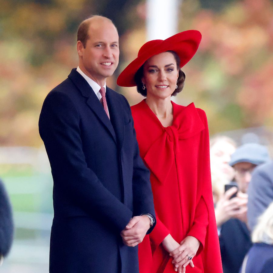 Prince William and Kate Middleton standing outside on the streets of London