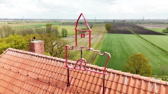 Schloss-Skulptur auf einem Hausdach © Screenshot 