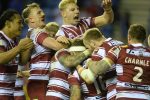 Wigan Warriors players celebrate after Sam Powell scores the crucial try