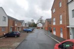 a red van is parked in front of a row of houses