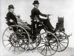 Gottlieb Daimler sitting in a motor vehicle
