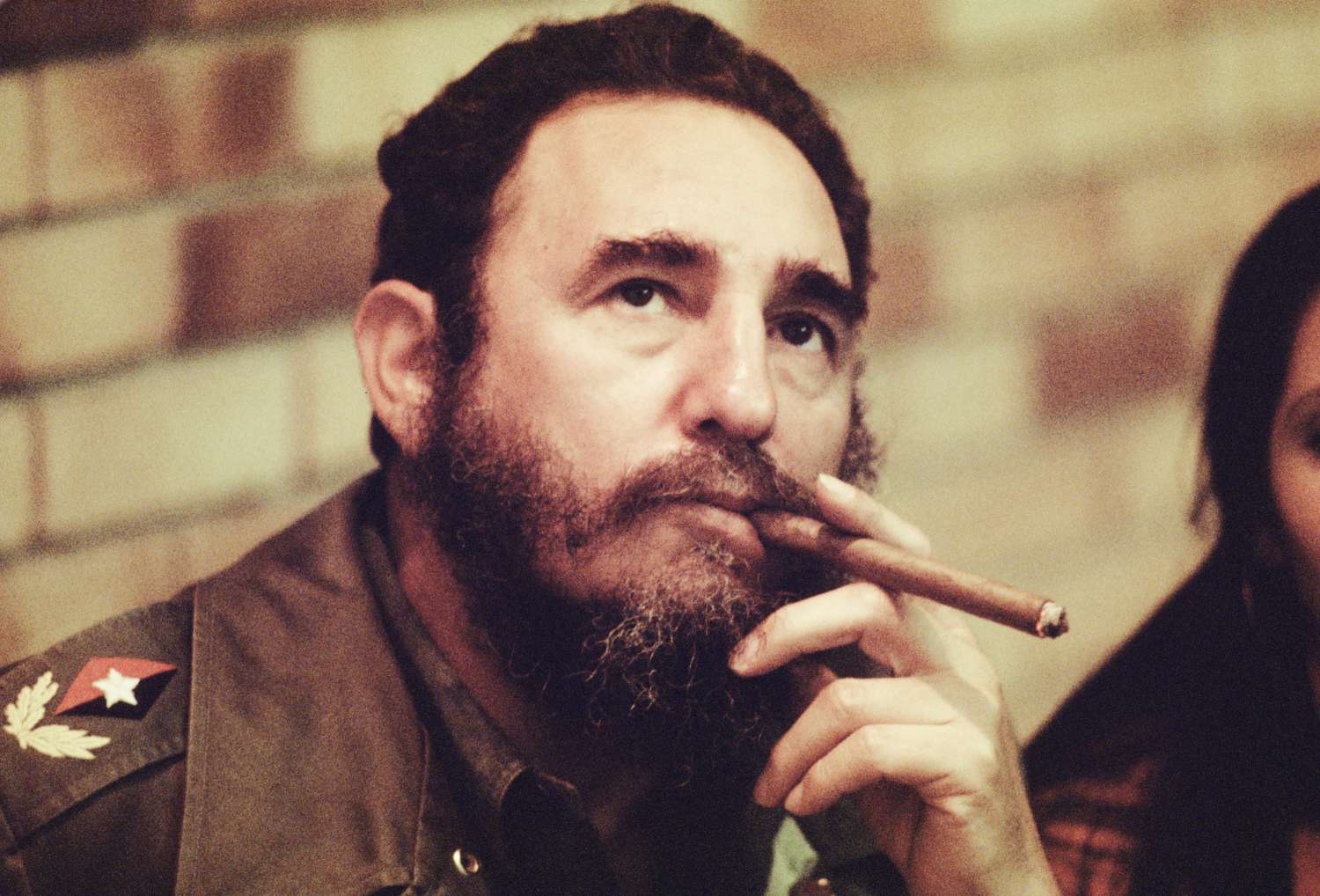 Fidel Castro smokes a cigar in his office in Havana, Cuba, circa 1977.