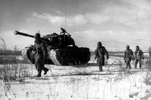 A column of troops and armor of the 1st Marine Division move through communist Chinese lines during their successful breakout from the Chosin Reservoir in North Korea.