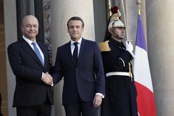 Iraqi President Barham Salih shakes hands with French President Emmanuel Macron