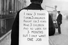 Man wearing sandwich sign looking for a job during the Great Depression\