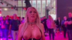 German cougar walks through an exhibition in Berlin with a cumshot on her face after a public threesome.