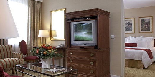 Suite with living room in foreground, bed in background