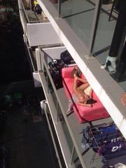 Slut Sunbathing Nude On Balcony Caught on Camera