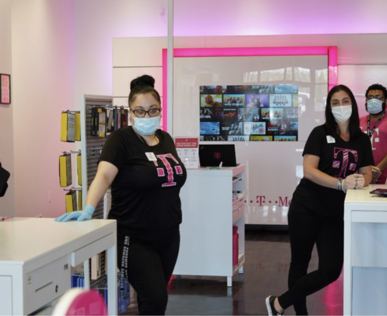A group of people wearing face masks in a store.