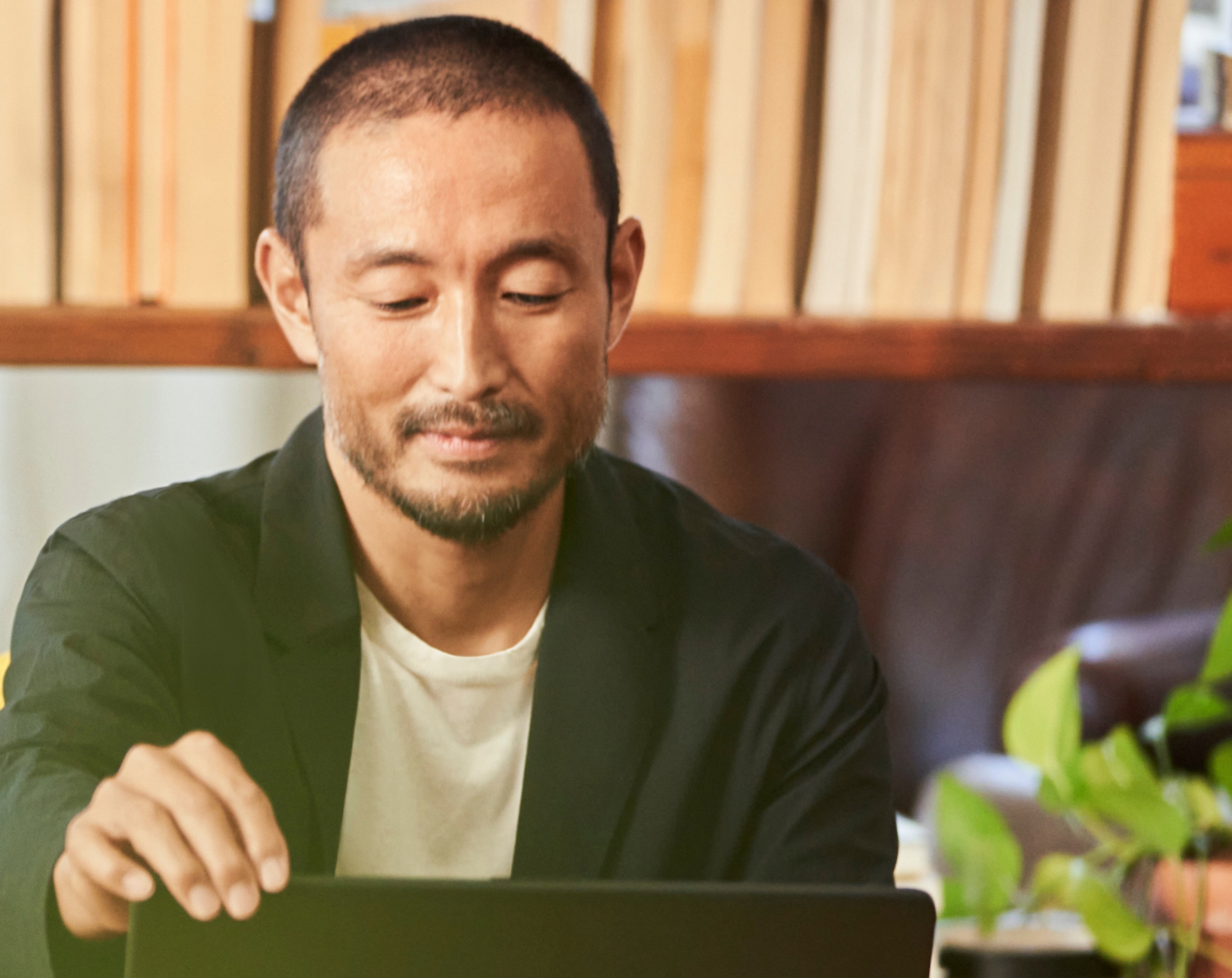 A man using a laptop in his home office