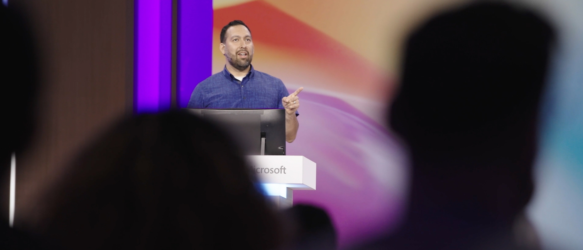 A man giving a presentation at a conference.