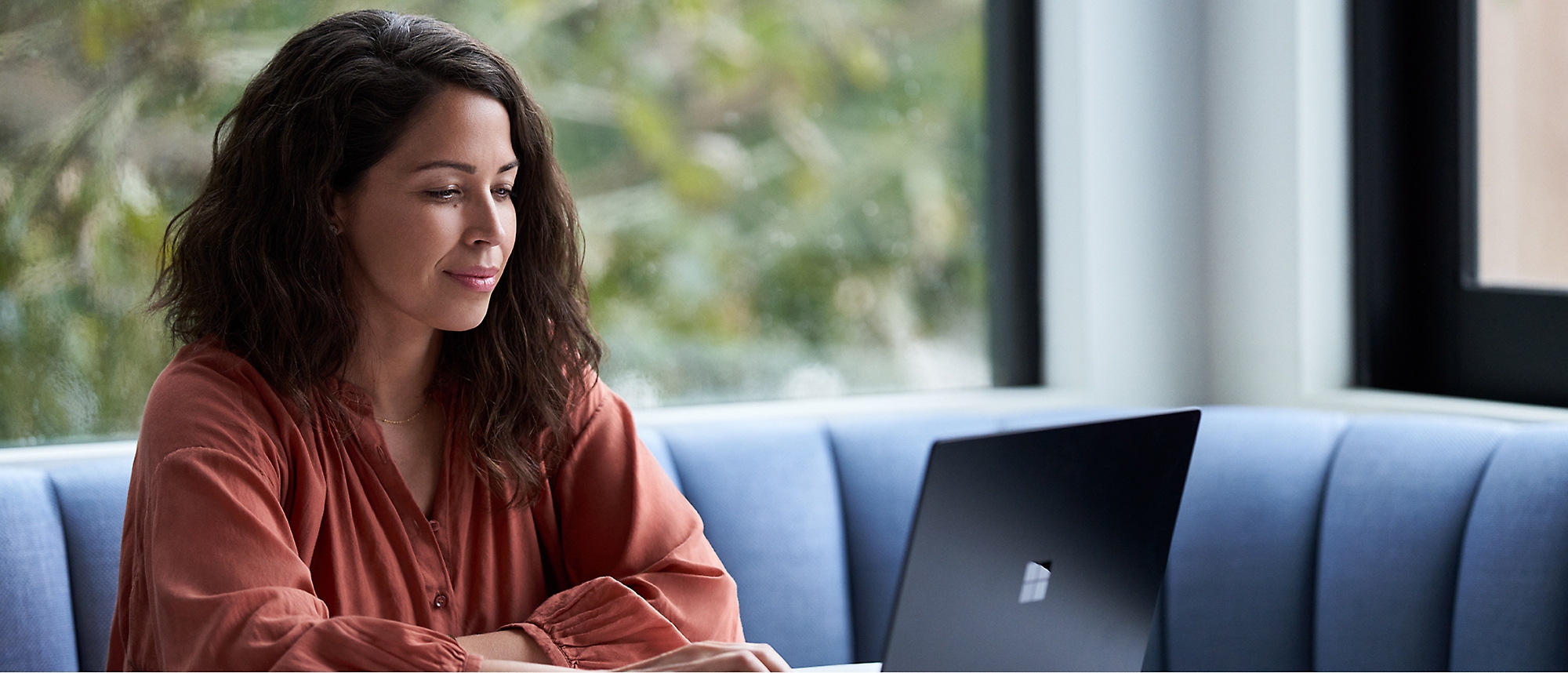 A woman using a laptop in an office.