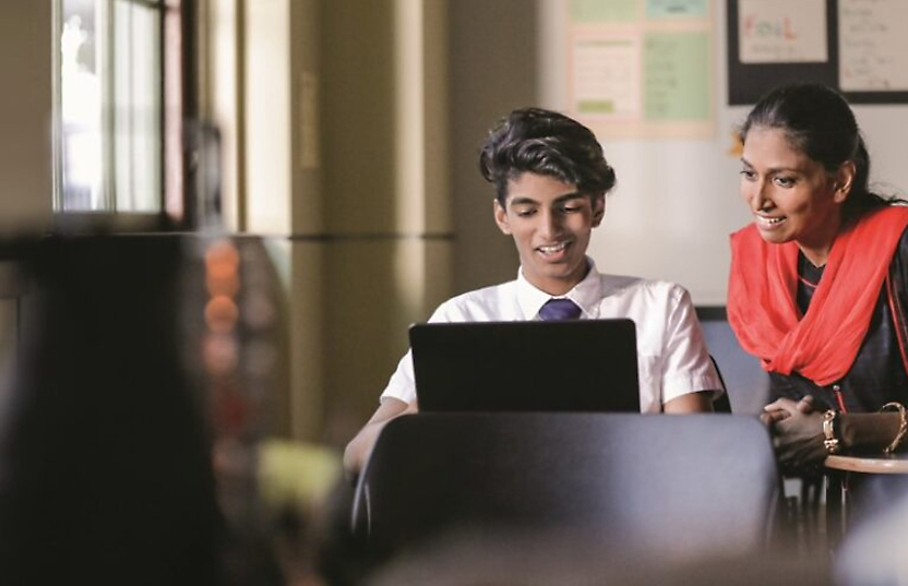 A group of business people working together on a laptop