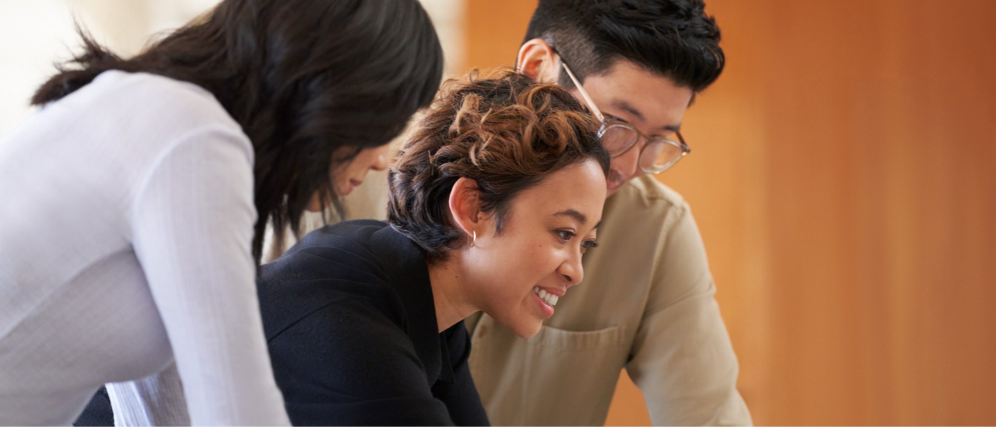 A group of people standing in office and have a discussion