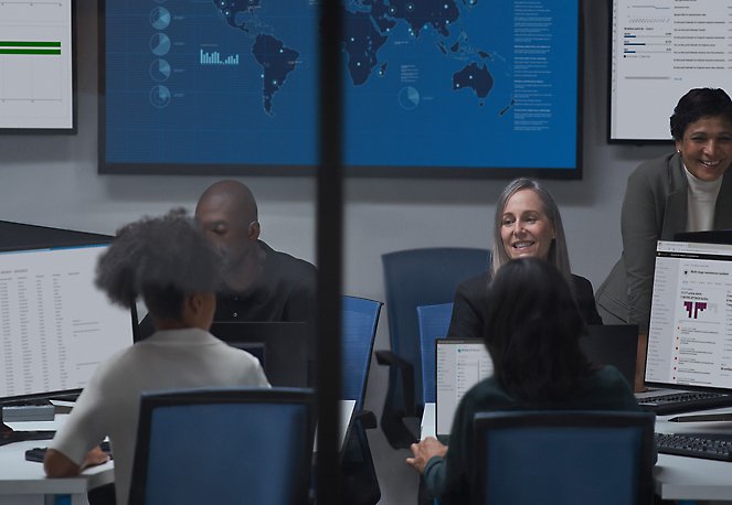 A group of people sitting in chairs and smiling.