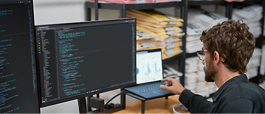 A man is working on a computer in a mailroom.