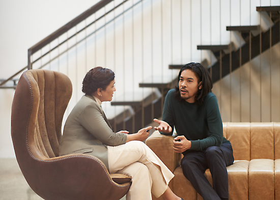 Two people sitting in a lounge having a conversation