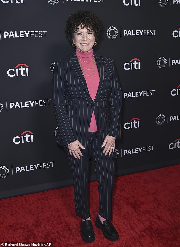 Comedian Susie Essman - who played Jeff's outspoken wife Susie Greene - ditched the caftans in favor of a pink turtleneck beneath a pin-stripe black pantsuit and matching loafers