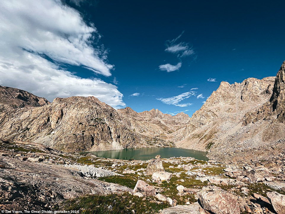 Voors finds 'the perfect spot to camp', pictured, high in Wyoming's Wind River Range. 'I have to stop and take it all in every once in a while,' he writes. 'The chances of me ever returning were quite slim.' Voors describes the area as 'a towering, flat monolith' rising above a 'turquoise, opaque river'. He adds: 'The trail wound through a meandering bed of blue-mauve sage. Late summer had dried out all the flowers. The sweet smell of sage in the morning never disappointed'