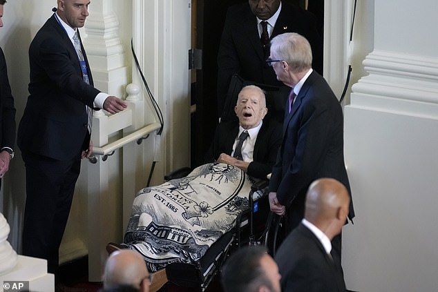In November, he made rare public appearance for his wife Rosalynn's memorial service, in a wheelchair and covered in a blanket depicting her face