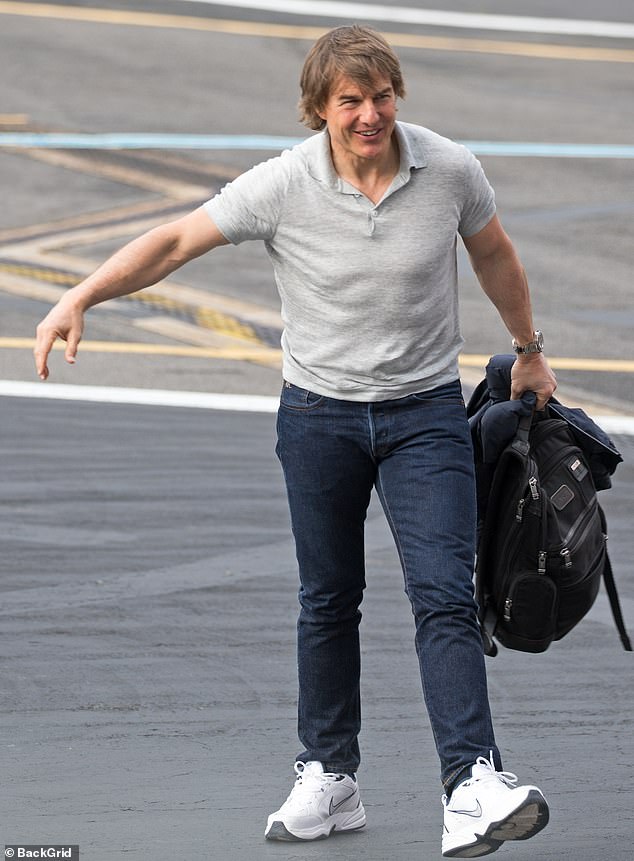 Tom Cruise, 61, covered his modesty in a casual grey polo shirt as he arrived at London Battersea Heliport on Tuesday