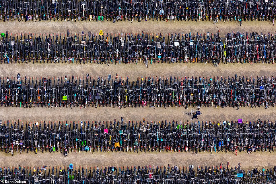 Donn says: 'The thrill of the flight and the ability to capture and share these moments with others is incredibly rewarding.' Above is RedLock District, an image of hundreds of bikes taken above Amsterdam