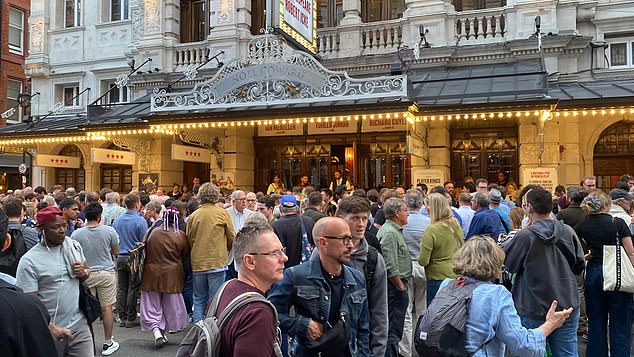 Members of the audience gather outside the Noel Coward Theatre in London after the fall