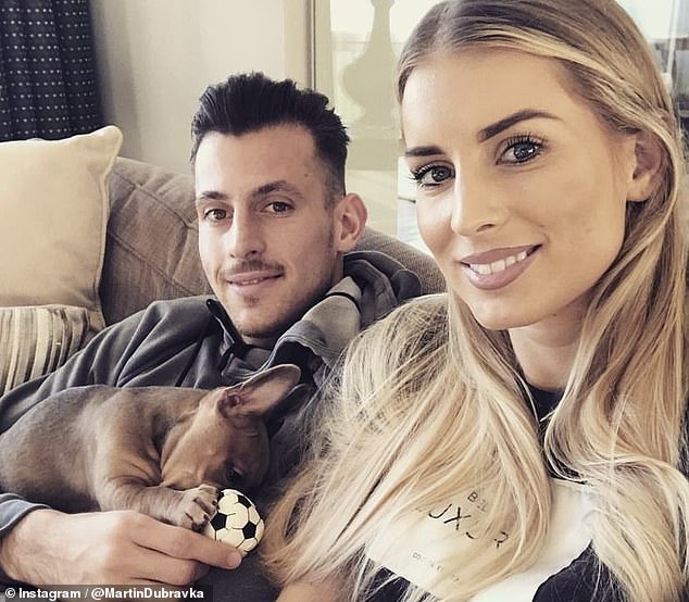 Lucia and Martin, who plays for Newcastle FC, are pictured together with their dog