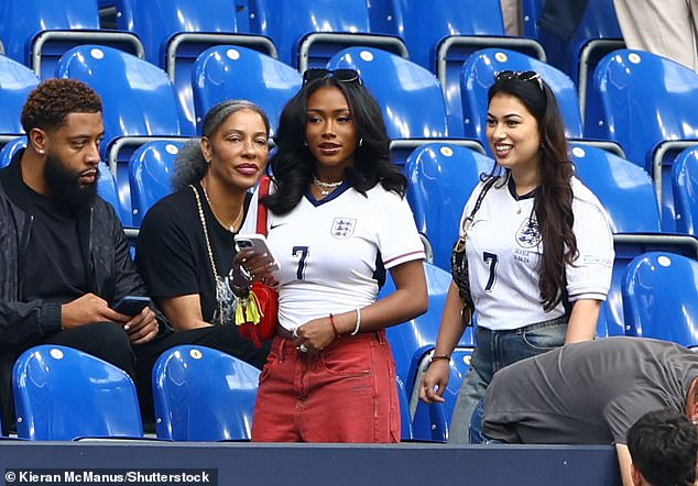 England winger Bukayo Saka's partner Tolami Benson (centre) was seen approaching her seat