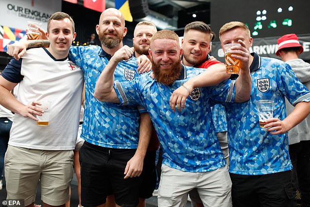 LONDON -- England fans strike a pose ahead of a public screening of the UEFA EURO 2024 Round of 16 soccer match between England and Slovakia at Boxpark Wembley in London