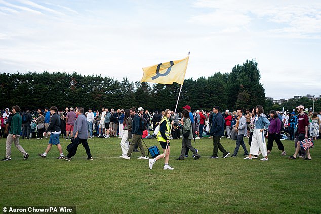 Spectators in the queue on day one of the Wimbledon Championships in London this morning