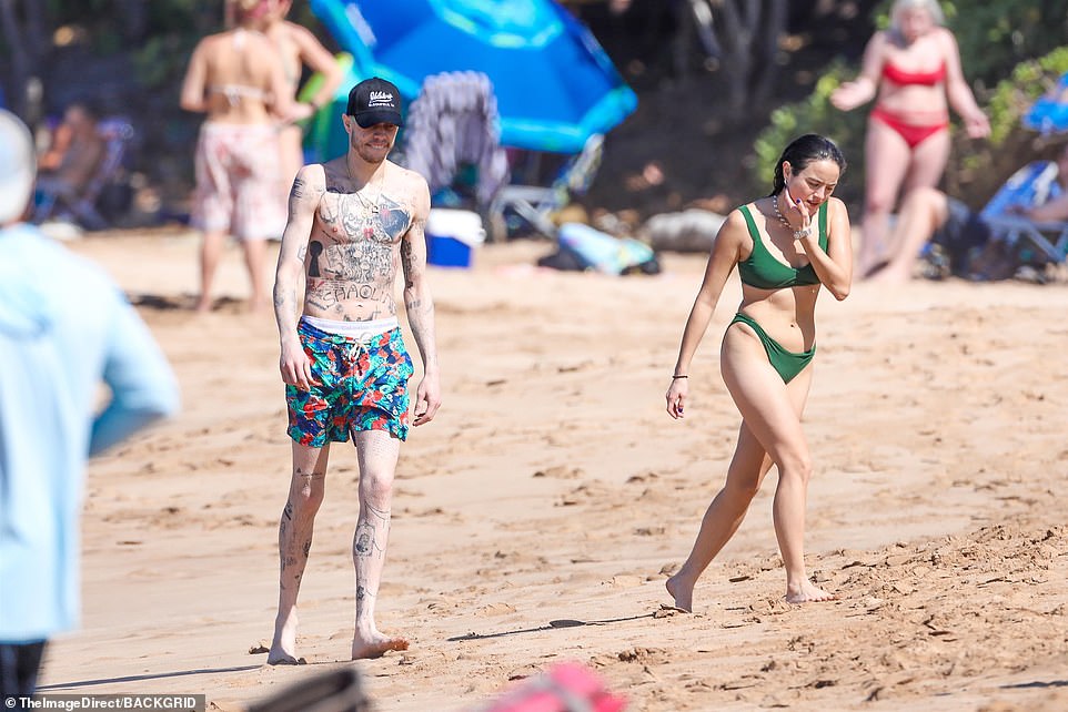 Crowded: The duo did not blend into the packed beach as Davidson flaunted his colorful hair and tattooed chest