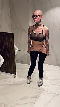 Juicy slut squirts in male bathroom with big tits on display
