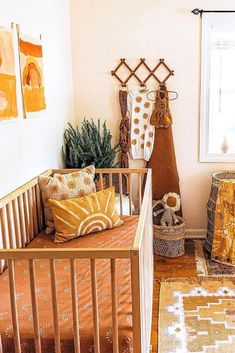 a baby crib in the corner of a room next to a window with yellow curtains