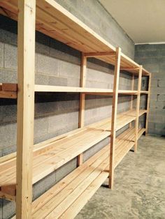 several wooden shelves in a room with concrete walls