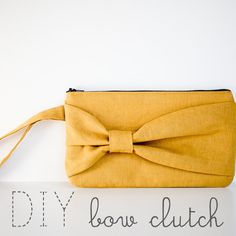 a yellow bow clutch bag sitting on top of a white sign with the words diy below it