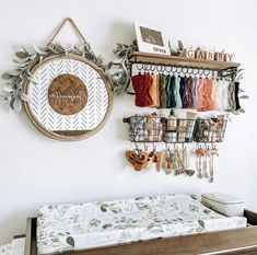 a baby crib with several items hanging on the wall