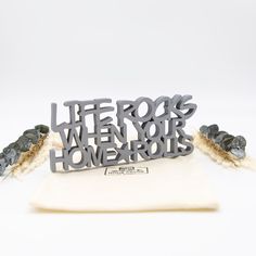 a metal sign that says life rocks when your homeworks