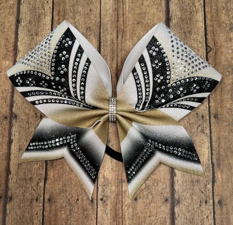 "Badda Bling Bows provides the highest quality bows on the market specializing in individual, practice and team bows and we uniform match.   This gorgeous cheer bow is covered in high facet crystals! Sublimated on white glitter gives this gorgeous bow a beautiful sparkly effect with crisp vibrant color!  Available in any color combo and any stone color. - FREE SHIPPING on all team orders. - Made with 3\" ribbon and premium nylon elastic hair bands that won't damage hair as they have no metal par Cheer Bows, Football Bows, Competition Bows, Bling Bows, Damage Hair, Bow Ideas, Cheer Bow, Elastic Hair Bands, School Mascot
