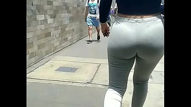 Latina in tight leggings walks the streets with thong visible