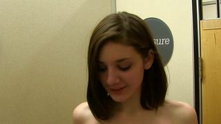 Brunette in changing room grabbing her boobs.