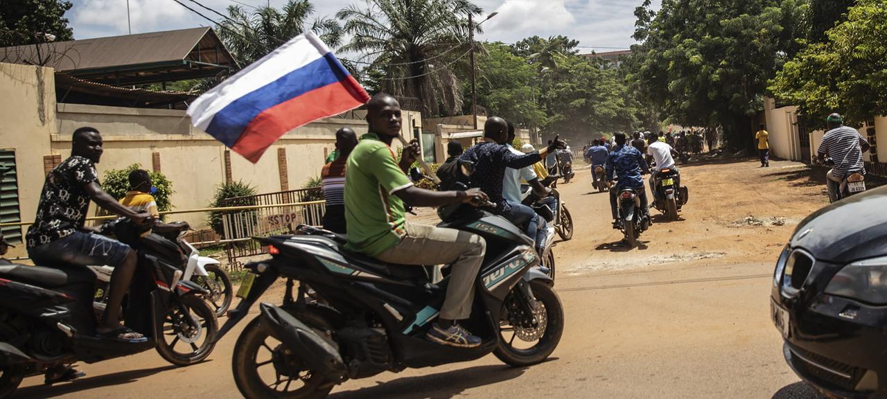 Anhänger von Ibrahim Traore schwenken bei einer Parade in den Straßen von Ouagadougou, Burkina Faso, eine russische Flagge.