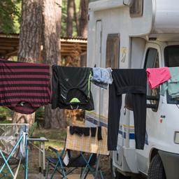 Wäsche hängt auf einer Leine vor einem Wohnmobil auf dem Naturcampingplatz am Springsee, Archivbild (Quelle: DPA/Patrick Pleul)