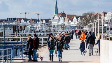 Touristen auf der Promenade von Travemünde.
