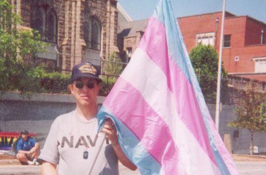 Monica Helms holding the original trans pride flag that she created in 1999. 