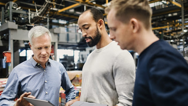 Three men looking at laptop